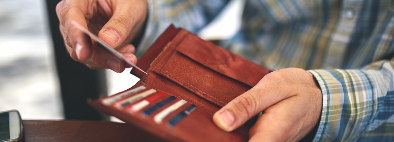 Man taking out a credit/debit card from wallet