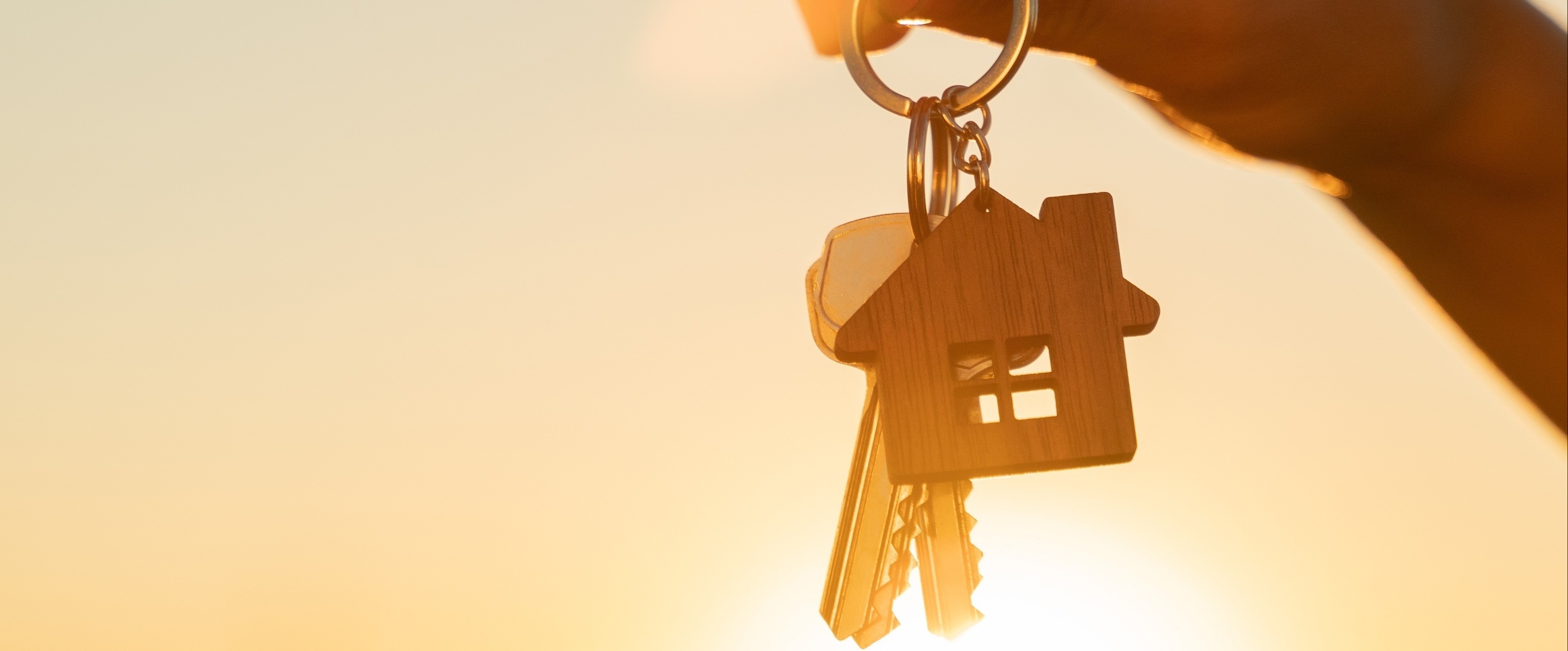 hand holding keys with a house key chain