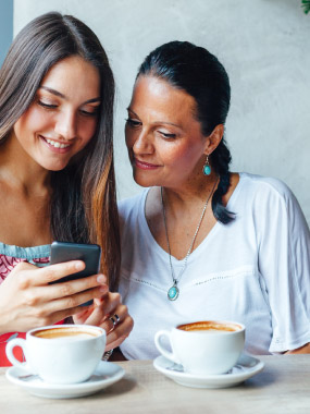 Mother and daughter using mobile phone