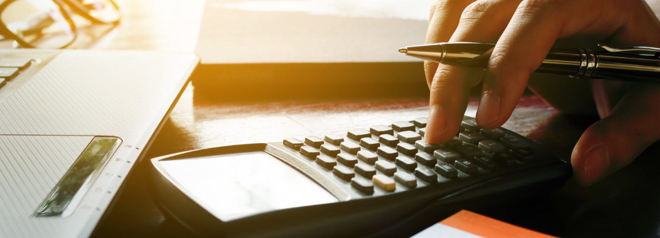 a man typing on a calculator