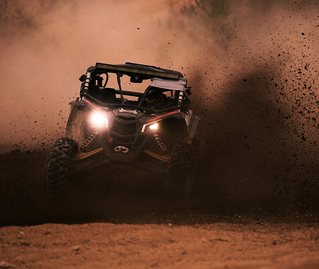 offroading vehicle kicking up mud 