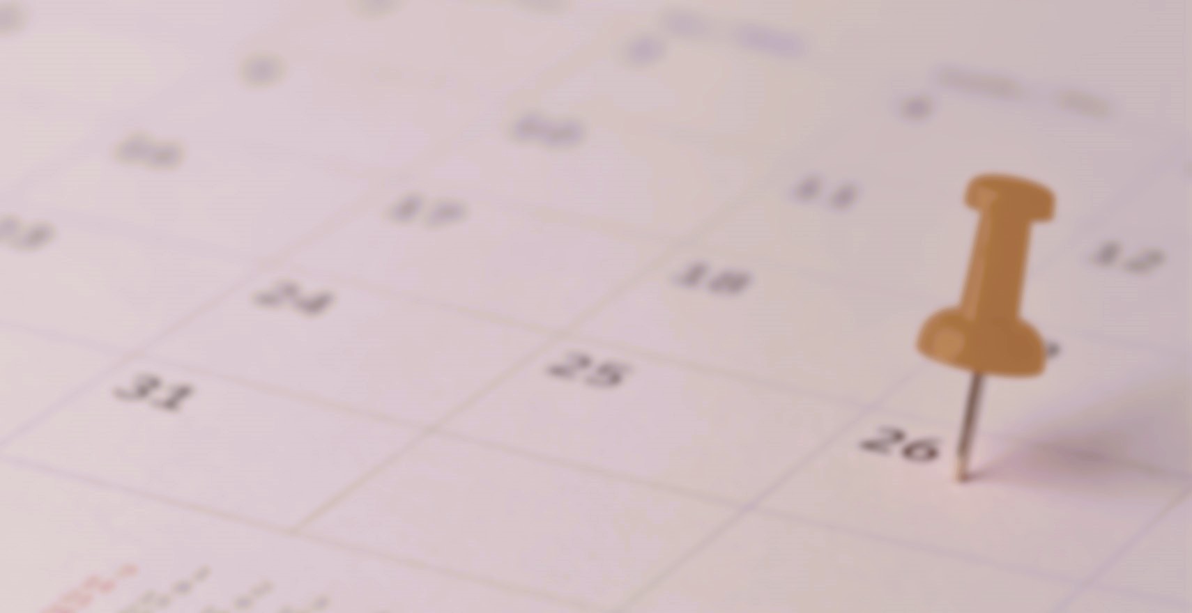 Calendar with a yellow push pin marking the 26th