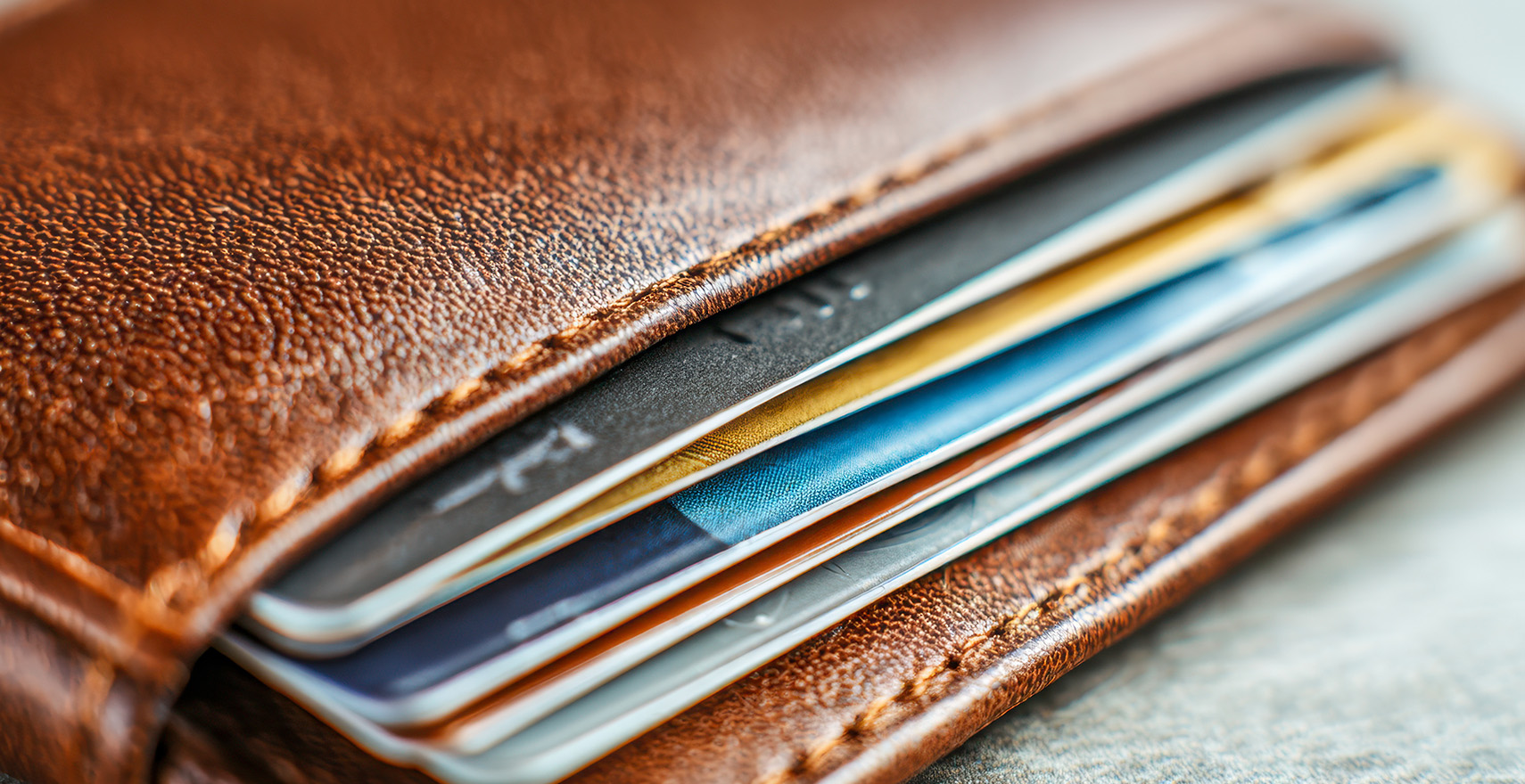Filled wallet with the edges of credit cards exposed.